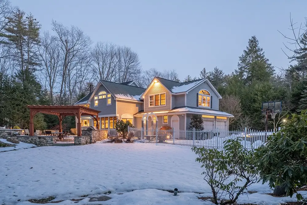 Winter evening view of Maine home